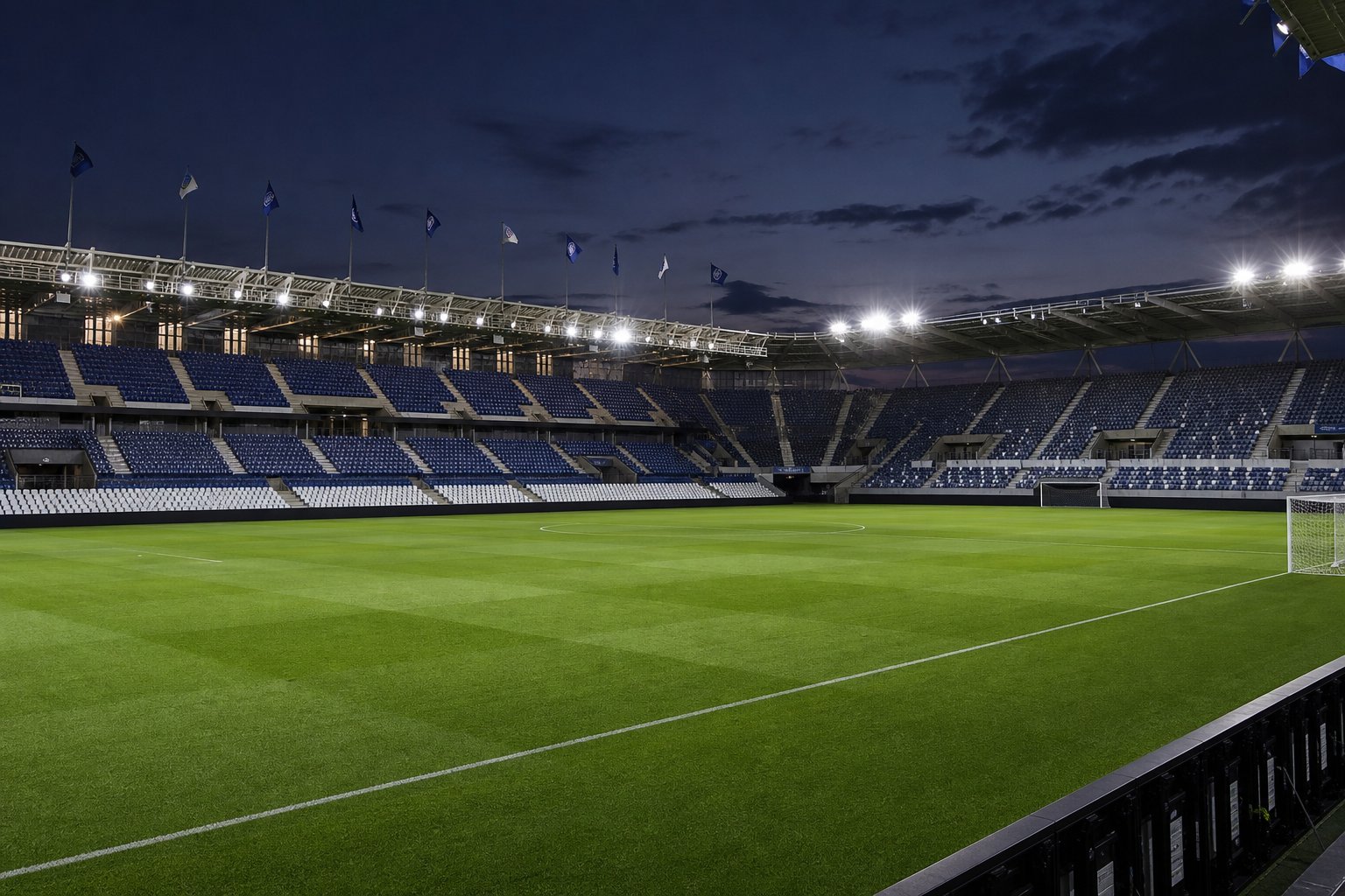 A football stadium glowing under floodlights at dusk before a European match